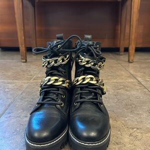 Carvella Boots. Black color and gold belt chain.
